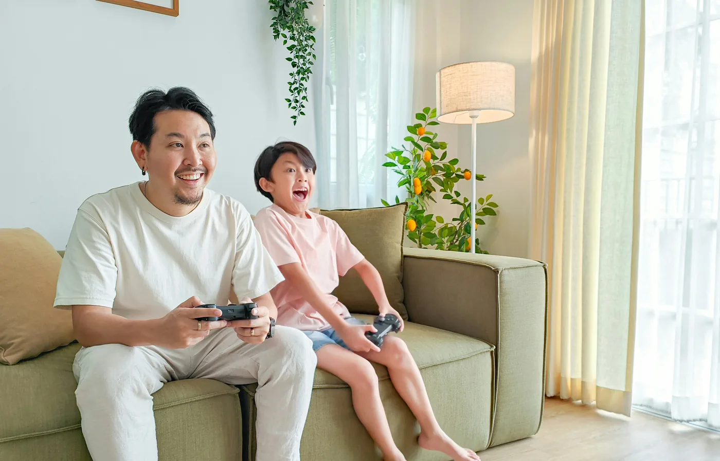 Father and child gaming together at home